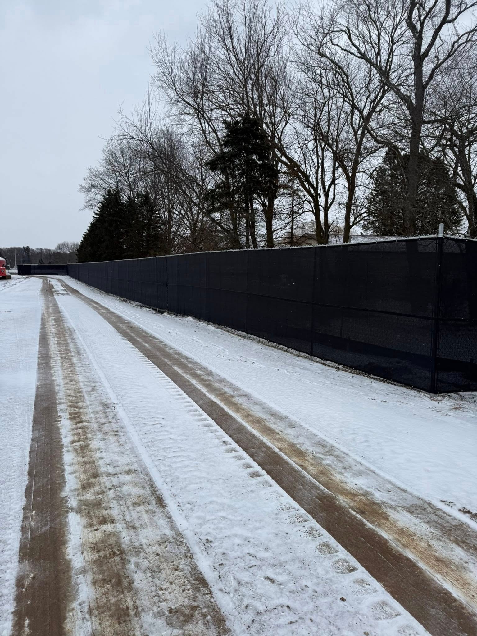 Outdoor fence line photo showing long run and open ground.